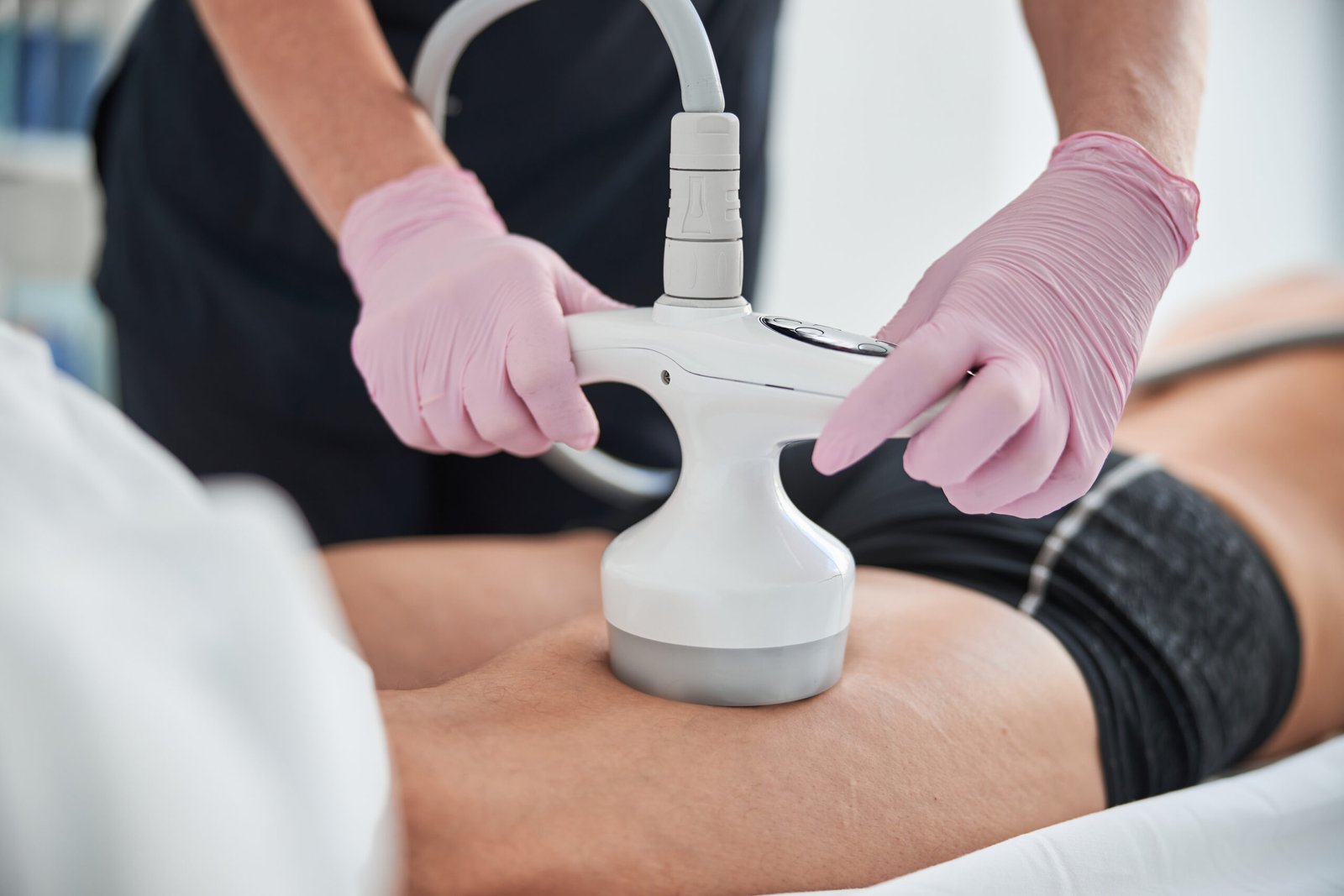 Cropped photo of a unrecognisable spa worker operating an ultrasonic cavitation machine